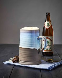 there is a beer and a mug on the table