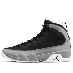 The Air Jordan 9 Particle Grey is a retro sneaker with a modern twist. This updated version of the '90s classic features a breathable black textile upper, speed laces, and tonal stitch detailing. The nubuck mudguard in a neutral grey finish wraps around the heel and extends up the mid-cut collar. Contrasting hits of crimson land on the sneaker's branding elements, including an Air Jordan tongue tag and a molded Jumpman emblem at the heel. Whether you're hitting the court or just hitting the streets, this sneaker is sure to turn heads. (AJ9/SNKR/Basketball) Carbon Color Lace-up Sneakers With Boost Midsole, Custom Black Mesh Sneakers With Branded Insole, Sporty Jordan Shoes With Abzorb Midsole For Streetwear, Dynamic Jordan Mid-top Shoes For Streetwear, Dynamic Mid-top Jordan Shoes For Streetwear, Sporty Jordan Lace-up Shoes For Streetwear, Sporty Lace-up Jordan Shoes For Streetwear, Mesh Basketball Shoes For Streetwear, Black Mesh High-top Sneakers With Rubber Sole