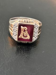 Delayed Shipping-we are away from our shop and won't be able to mail until July 8 Larry, Liam Or Linda would love this ring. Sterling and 10K gold signet/monogram set on faux red ruby backing. Lots of detail will make this a special ring for that special someone. SEE PHOTOS Ring is marked Sterling/10K and a SA incised signature  Ring size 10 1/2 - 11 Ask questions if unsure Condition is good, this is VINTAGE, used and might show wear Check our shop to see more Vintage items www.etsy.com/shop/missenpieces Signature Ring, Photo Ring, Signature Rings, 10k Gold Ring, Monogram Ring, Signet Rings, Special Ring, Letter L, Red Band