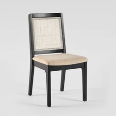 a black chair with a beige seat and back cushion on the bottom half of it