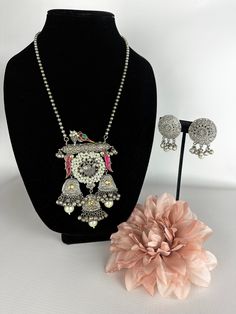 This unique tribal jewelry piece is perfect for a vibrant and fun look and is made in oxidized silver finish plating with matching earrings to go with the necklace. The Design is made of birds and Pink Stones for a splash of color on this modern sabyasachi piece along with beautiful matching earrings to go perfectly with the necklace! A vibrant and modern look for any event! This lightweight and elegant necklace is perfect for any bridesmaid, bride, sangeet or any occasion or event as a gift for Traditional Multicolor Jewelry Sets With Oxidized Finish, Silver Peacock Design Jewelry Sets For Festivals, Silver Peacock Design Jewelry For Party, Multicolor Oxidized Jewelry Sets For Wedding, Multicolor Oxidized Finish Jewelry Sets For Wedding, Traditional Multicolor Oxidized Jewelry Sets, Traditional Multicolor Oxidized Finish Jewelry Sets, Metal Jewelry With Peacock Design For Party, Unique Jewelry With Oxidized Finish For Festive Occasion