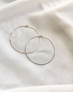 Take your look to the next level with our large simple hoop earrings. Wear with any outfit for a sleek and sophisticated look. These versatile everyday hoops are a classic favorite to have in your collection. Available In Sterling Silver, 14k Gold Filled or 14k Rose Gold Filled. Details: Simple and Delicate Medium Hoop Earrings Approximately 2" In Diameter Minimalist Thin Wire Hoops Lightweight For Comfort Slightly Hammered Texture Design ★ JEWELRY CARE ★To extend the lifecycle of your jewelry a Hoop Earrings Large, Simple Hoop Earrings, Medium Hoop Earrings, Large Hoop Earrings, Design Jewelry, Texture Design, Jewelry Care, Gold Filled, Jewelry Design