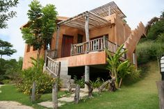 the house is made out of wood and has stairs leading up to it's second floor