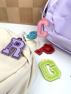 Our personalized bag tags are perfect for backpacks, lunch bags, sports bags, luggage tag, or even as an oversized keychain. Choose from solid colors with white background, our adorable color combinations, or color gradients. We can also print a name on the tag, or leave it blank.  Our tags are guaranteed to last under the harshest conditions for a minimum of six months. If your child manages to break it in that time, just send us a photo of the damage and we will send you a new one right away (just pay $5 postage).  Each bag tag comes with a durable silicon loop to easily attach to your bag. Each letter is 2.5 inches high (total height is 2.9, including the eyelet), but the width of the letter will vary depending on the letter you choose (W will be much wider than the letter I, for exampl Teacher Keychain, Personalized Bag Tags, The Letter I, Color Gradients, Keychain Backpack, Initial Keychain, Letter Bag, Varsity Letter, Sports Bags