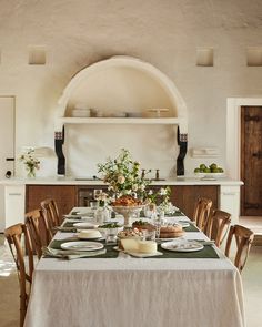 the table is set with plates and bowls