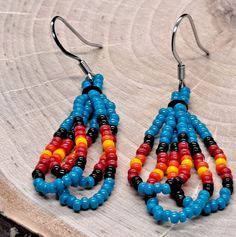 American Indian Style Beaded Dangle Earrings! Each earring features a mesmerizing arrangement of vibrant beads, creating a captivating and eye-catching design. Whether you're attending a festival or simply looking to make a statement, beaded dangle earrings are guaranteed to turn heads and become a cherished addition to your jewelry collection.  - Stainless steel ear wire Be sure to check out my other handmade items  https://lesliesjewelryco.etsy.com Multicolor Dangle Beads With Ear Wire, Multicolor Polished Beaded Earrings As Gift, Multicolor Polished Beaded Earrings For Gifts, Multicolor Teardrop Earrings With Colorful Beads, Multicolor Polished Beads Earrings For Gift, Gift Multicolor Polished Beaded Earrings, Adjustable Chandelier Earrings With Colorful Beads, Multicolor Beaded Teardrop Dangle Earrings, Multicolor Large Beads Drop Earrings