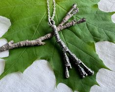 A gorgeously textured maple twig branch necklace pendant in sterling silver ... naturally beautiful botanical jewelry. The maple tree is symbolic of strength, wisdom, endurance, balance, change and protection. Its scientific name is acer, from the Latin meaning sharp, referring to its pointed leaves. - approximate measurement - 1 7/8" (47mm) x 3/4" (17mm) widest where it branches out  - approximate twig thickness 1/8" (3mm) -  the maple twig pendant is 3D and beautifully textured all around - the suspension loop inside measures 6/32" (5mm) - metal - sterling silver (.925 silver) - photographed with a US dime and inch ruler for scale - select the maple twig charm only or suspended on a sterling silver cable chain, select length - select chain finish - shiny silver or antiqued oxidized chain Tree Branch Jewelry, Branch Jewelry, Wax Seal Necklace, Twig Branch, Inch Ruler, Branch Necklace, Scientific Name, Botanical Jewelry, Maple Tree