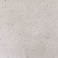 a close up view of the surface of a white marbled counter top, with small speckles on it