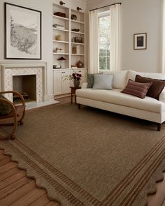 a living room filled with furniture and a fire place in front of a book shelf