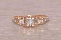 an antique diamond ring on a wooden surface