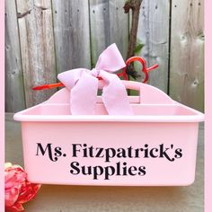 a pink plastic container with a bow on it and the words ms fitzpatrick's supplies