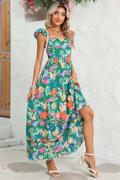 This flowy dress is perfect for warm weather or beach outings. The ruffled shoulder strap adds movement and an extra layer of visual interest. It showcases a vibrant and colorful floral pattern, creating a fresh and summery vibe The high waist design accentuates the curves and creates a feminine silhouette. Wholesale maxi dresses available for bulk orders, great for retailers Fabric Contents: Product Weight: 0.73 kgMaterial: 100%Polyester Summer Tropical Print Floral Dress For Garden Party, Summer Floral Dress With Tropical Print For Garden Party, Breezy Summer Maxi Dress With Ruffles, Floral Print Sundress For Summer Outings, Floral Sundress For Summer Outings, Summer Sundress With Ruffled Straps For Brunch, Flowy Sundress With Ruffled Straps For Brunch, Multicolor Floral Print Sundress For Summer Outings, Multicolor Floral Sundress For Beach Season