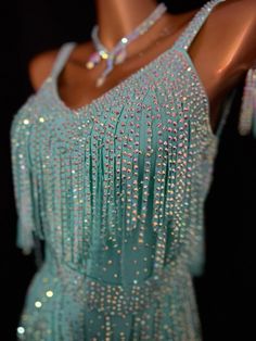 a woman's dress with beading and fringes on it