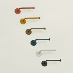 five different colored handles and knobs on a white surface