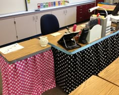 an office desk covered in polka dot fabric