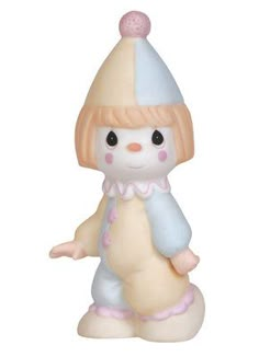 a white and pink figurine with a snowman hat on it's head