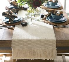 the table is set with dishes and place settings for two people to sit down at