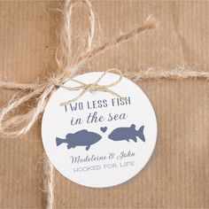 two less fish in the sea wedding ornament with twine on brown wrapping paper