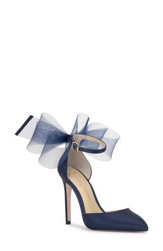 A voluminous bow stands out at the heel counter of an elegant satin pump framed by a pointy toe and stiletto heel. 3 1/2" heel Adjustable ankle strap with buckle closure Textile upper/synthetic lining and sole Imported