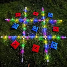 a group of lights that are sitting in the grass on top of some bricks and sticks