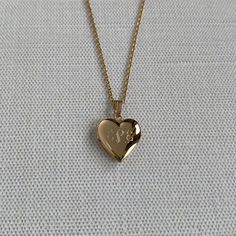 A child's plain polished 14K yellow gold-filled heart-shaped locket on a cable chain necklace. The outer shell is solid gold pressure-bonded to an inner core of high-quality brass. Locket Dimensions: 13 mm W x 21 mm H Chain Length: 15" Classic Heart Shaped 14k Gold Locket Necklace, Classic 14k Gold Heart Locket Necklace, Heart-shaped 14k Yellow Gold Locket Necklace, Heart Shaped 14k Yellow Gold Locket Necklace, 14k Yellow Gold Heart Locket Necklace, Gold Heart Pendant Locket Necklace With Hallmark, Gold Heart Locket Necklace In 14k Gold, 14k Gold Locket Necklace With Heart Charm For Keepsake, 14k Gold Heart Locket Necklace