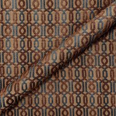 a brown and blue patterned fabric with an interlocked design on the bottom half