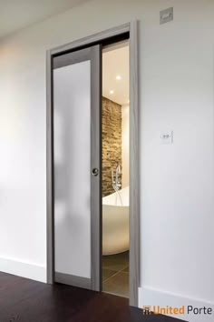 an open door leading to a bathroom with a tub