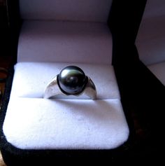 Huge 10mm + Black Real Pearl Ring set in a smooth modern style Sterling Silver setting. Choose Dark or Light Bad Moon Rising Tahitian Black Natural Color Cultured Pearl As seen worn by the lovely Wylona Hayashi / https://m.facebook.com/photo.php?fbid=311665265654834&set=a.160040784150617.1073741825.129240783897284&type=1&theater Size 6 6.5 7 7.5 8 8.5 9 9.5 10 10.5 ring Sterling silver ring is sizable for $30 more from size 4 4.5 5 5.5 11 11.5 12 12.5 13 Cultured lovely Pearl may be Anniversary Black Tahitian Pearl Ring, Classic Black Pearl Ring, Formal Black Tahitian Pearl Ring, Classic Black Pearl Ring For Anniversary, Tahitian Pearl Ring Jewelry As Gift, Black Tahitian Pearl Ring, Tahitian Pearl Ring Jewelry Gift, Classic Tahitian Pearl Rings As Gift, Silver Tahitian Pearl Ring