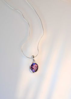 Add a hint of color to your jewelry collection with our classic oval Amethyst gold necklace handmade in .925 silver base and thick 18k gold vermeil. This classic with a touch of modern necklace features a single 14mm x 10mm deep purple genuine amethyst set in a sturdy bezel setting. Comes with flat cable chain to create a unique look in the length of your choice.  DETAILS: * Dimensions: Stone - 14mm x 10mm, Pendant total length 23mm * Material: 925 sterling silver base, natural genuine amethyst stone, 18k thick gold plating (nickel free), thick anti tarnish gold filled paperclip chain * All of our gemstones are natural high grade genuine stones, tested by GIA approved. Also available in 18k Gold Vermeil * CHAINS - Silver necklace comes with our Snake Chain and Vermeil Necklace comes with t Classic Amethyst Pendant Necklace, Classic Oval Amethyst Necklaces, Classic Amethyst Pendant Jewelry, Classic Amethyst Necklace For Gift, Fine Jewelry Amethyst Oval Pendant, Classic Sterling Silver Necklace With Oval Cabochon, Modern Purple Oval Jewelry, Modern Oval Purple Jewelry, Classic Oval Faceted Necklace