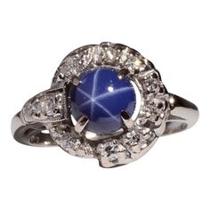 This is part of Chairish’s Fine Jewelry assortment.  Estate synthetic star sapphire & diamond ring. This 14 karat white gold ring features a synthetic star sapphire accented with 10 single cut diamonds at .16 carat total weight. The diamonds have VS2 clarity and G-I color. This estate ring is a size 5.5. [SJ 9268 P]  Metal: 14k Gold,White Gold  Stone: Diamond,Star Sapphire  Stone Cut: Round Cut Star Sapphire Stone, Vintage Platinum Rings, 1 Carat Diamond Ring, Estate Rings, Diamond Wedding Sets, Star Sapphire, Sapphire Diamond Ring, Diamond Star, Modern Ring