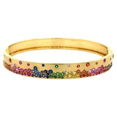 18K Yellow Gold Bracelet with Multi-Color Gemstones and Diamonds 23 Blue Sapphires - 0.48 CT 5 Diamonds - 0.06 CT 8 Green Garnets - 0.16 CT 18 Orange Sapphires - 0.40 CT 33 Pink Sapphires - 0.76 CT 13 Yellow Sapphires - 0.32 CT 18K Yellow Gold - 18.64GM SIZE - 48X58 MM Experience the mesmerizing beauty of our exquisite 18K gold bracelet, adorned with a stunning array of unique, intricately cut gemstones. Each piece features a captivating combination of vibrant multi-color sapphires, green garnet Fine Jewelry Yellow Gold Multi-stone Bangle, 14k Yellow Gold Multi-stone Bracelet, Luxury Yellow Gold Multi-stone Diamond Bracelet, Elegant Multicolor Multi-stone Cuff Bracelet, Luxury Multicolor Multi-stone Gold Bracelet, 18k Gold Bracelet, Green Garnet, Orange Sapphire, Yellow Gold Bracelet