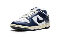 The Women’s Nike Dunk Low PRM "Vintage Navy" is a women’s-exclusive colorway of the retro basketball shoe with a vintage-inspired design.  The “Vintage Navy” honors the Dunk’s storied history as a mid-1980s college basketball team shoe with its aged, vintage look.  The cream rubber midsole mimics the oxidation process rubber undergoes after years of use.  Up top, the shoe features a white leather base with Vintage Navy leather overlays and Swoosh branding that have a slight sheen and textured fi Retro Basketball Shoes, Retro Basketball, Basketball Team, Navy Shoes, Navy Leather, Basketball Teams, College Basketball, Vintage Inspired Design, Nike Dunk Low