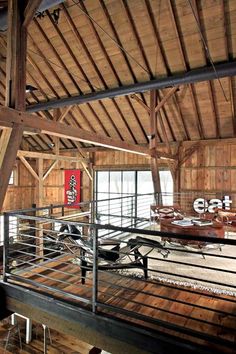 the inside of a wooden building with metal railings