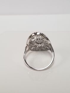 "Thanks for shopping our vintage estate store. We tend to sell well below wholesale and truly hope you enjoy all of our items. Many of the items are one of a kind, so please enjoy scrolling through the pictures and hopefully something will catch your eye. Black spots are from reflections. Nice estate sterling silver 925 .25ct Cz Diamond gem stone filigree cocktail ring. An estate ring, came from a jewelry store that was closing. Ring size: 7 or 8 Setting: 7/8\" by 5/8\" Band width: 1.5mm Weight: Classic Collectible Diamond Ring With Vvs Clarity, Collectible Diamond Ring With Brilliant Cut, Classic Silver Halo Ring With Diamond Accents, Classic Silver Diamond Ring With Accents, Collectible Cluster Ring With Brilliant Cut, Brilliant Cut Diamond Ring For Collectors, Classic Silver Filigree Ring With Diamond Accents, Vintage Silver Halo Ring With Round Cut, Classic Silver Oval Diamond Ring