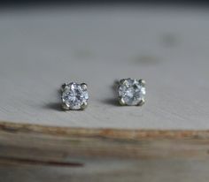 Stunning 14k white gold diamond stud earrings. Each round diamond is .10ct for a .20 TCW. The diamonds are H-I color and SI2 clarity. These earrings come with 14k white gold friction backs. The settings are a decorative stud mounting, sweet and feminine. Each diamond is 3mm in diameter. Perfect set of studs to pair with other earrings or wear on their own. Ready to Ship! Silver Single Diamond Earrings Fine Jewelry, White Gold Platinum Diamond Earrings With Single Diamond, Platinum White Gold Diamond Earrings With Single Diamond, Diamond White Earrings With Prong Setting As Gift, Timeless White Gold Diamond Earrings For Gift, Silver Diamond Earrings With Single Diamond, Timeless White Gold Diamond Earrings As Gift, White Diamond Earrings With Single Diamond, Dainty White Diamond Earrings With Brilliant Cut