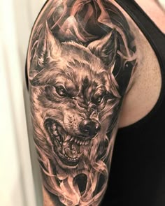 a man with a wolf tattoo on his arm