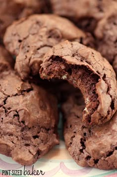 chocolate cookies are cut in half on a plate