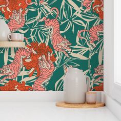 an orange and green wallpaper with pink tigers on it in a room that has white walls