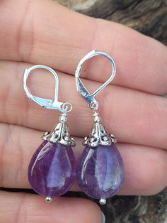 These natural purple amethyst teardrop shape are perfect for especial occasion or everyday wear. Length ( with lever back ) is around 1 1/2 inches.  The earrings with sterling silver lever back. The earring artive in gift box with beautiful rubbon for easy gift giving. Thank you for looking! Handmade Amethyst Teardrop Crystal Earrings, Purple Amethyst Teardrop Earrings, Purple Amethyst Drop Teardrop Earrings, Lavender Teardrop Jewelry With Ear Wire, Purple Gemstone Teardrop Earrings, Handmade Amethyst Teardrop Earrings, Amethyst Teardrop Crystal Earrings, Purple Nickel-free Teardrop Dangle Earrings, Purple Dangle Teardrop Earrings With Ear Wire