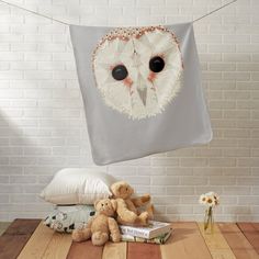 an owl is hanging on a clothes line with two teddy bears in front of it