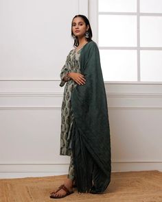 Experience luxury and elegance in our Forest Green Block Printed Suit Set. Crafted from fine mul-mul, this set showcases a classic traditional block print in a deep forest green hue. The set also includes a beautifully complementing dupatta adorned with delicate bead work along its edges. Elevate your wardrobe with this exclusive and timeless piece. No. of pieces - 3 piece set. Color - Green. Fabric - Mul-Mul, Cotton. Washing Instructions - Dry Clean. Green Palazzo Set With Dabka Details, Green Dabka Palazzo Set For Transitional Season, Transitional Green Dabka Palazzo Set, Green Kurta With Printed Motifs, Traditional Drape, Green Kurta With Printed Motifs, Green Designer Pant Set For Diwali, Festive Green Traditional Drape Pant Set, Festive Green Pant Set With Traditional Drape, Designer Green Pant Set With Zari Work