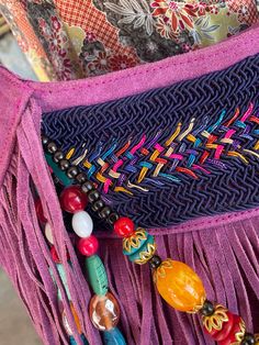 Orchid Leather Beaded Fringe Purse Each bag is unique and totally one of a kind! Room enough for all your daily essentials, this purse matches any bohemian style outfit and more. Featuring tassel and bead details, and so much fun fringe! Approx. 13" x 12" x 3" Zipper closure, 1 inside zipper pocket Bohemian Beaded Shoulder Bag For The Beach, Bohemian Beaded Shoulder Bag For Beach, Bohemian Shoulder Bag With Tassels For Festivals, Bohemian Festival Bags With Beaded Fringe, Bohemian Leather Bags As Fashion Accessory, Bohemian Leather Bag With Tassels, Bohemian Multicolor Shoulder Bag With Tassels, Beaded Bohemian Shoulder Bag For Festival, Purple Beaded Shoulder Bag For Everyday Use