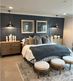 a bedroom with blue walls and white bedding