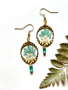 This lightweight pair of earrings was made using real flowers, leaves, and resin.  Accented with faceted glass charms Gold components and nickel free earring hooks. Bohemian Dangle Earrings With Pressed Flowers, Bohemian Drop Earrings With Pressed Flowers, Bohemian Dangle Earrings With Birth Flower, Green Botanical Drop Earrings Jewelry, Nature-inspired Dangle Earrings With Pressed Flowers, Bohemian Pressed Flowers Drop Earrings, Unique Flower-shaped Earrings With Pressed Flowers, Unique Flower Earrings With Pressed Flowers, Bohemian Flower Earrings With Birth Flower Details