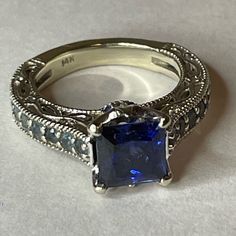 a fancy ring with a blue stone in the center