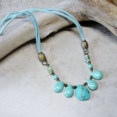 "Rustic southwestern styling in this beaded faux suede aqua cord necklace. Antique brass beads accent tear drop turquoise blue magnesite beads. The focal beaded segment is linked to soft faux suede aqua blue ties that are accented with antique brass beads and links and crimped to a matching lobster claw closure. Length of the necklace is 24\" All of my jewelry items come boxed and lace ribbon tied and tagged for easy gifting. This necklace is ready to ship." Adjustable Beaded Necklace With Teardrop Pendant, Bohemian Teardrop Beaded Necklaces With Adjustable Fit, Southwestern Style Adjustable Teardrop Necklace, Bohemian Teardrop Beaded Necklaces, Bohemian Beaded Teardrop Turquoise Necklace, Adjustable Teardrop Turquoise Necklace With Natural Stones, Adjustable Bohemian Beaded Necklace With Teardrop Pendant, Bohemian Adjustable Beaded Necklace With Teardrop Pendant, Bohemian Turquoise Necklace With Adjustable Cord