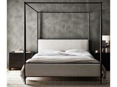 a four poster bed with white linens in a gray room, next to a night stand and nightstand