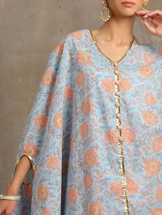 Heer Firoza Blue Cotton Printed Cape Set by Maison Shefali now available at Trendroots Blue Chikankari Embroidered Palazzo Set For Summer, Blue Chikankari Embroidery Palazzo Set For Summer, Summer Blue Palazzo Set With Chikankari Embroidery, Blue Chikankari Embroidered Sharara For Spring, Spring Blue Sharara With Chikankari Embroidery, Blue Sharara With Chikankari Embroidery For Spring, Blue Chikankari Embroidery Sharara For Spring, Bohemian Blue Palazzo Set With Printed Motifs, Blue Floral Print Sharara For Eid