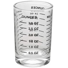 a measuring glass filled with liquid on top of a white surface and labeled ounces