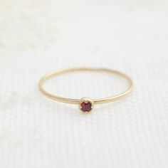 Ruby, July birthstone is set on Envero Jewelry's signature Dahlia setting which has a milgrain around the bezel setting to add elegant and feminine look to this simple ring. Choose from 2 or 3mm natural ruby and solid 14k yellow, rose or white gold. Perfect for simple ruby engagement ring - petite ruby matches perfectly when you wear it with our stack rings. Shop for matching ring: https://www.etsy.com/shop/EnveroJewelry?ref=l2-shopheader-name&section_id=17732059 ♦♦2mm Ruby ring♦♦ :: Small r Garnet Birthstone Ring In Fine Jewelry Style, Heirloom Solitaire Birthstone Ring Gift, Heirloom Style Solitaire Birthstone Ring As A Gift, Fine Jewelry Red Birthstone Stackable Rings, Red Birthstone Stackable Rings Fine Jewelry, Elegant Stackable Ruby Birthstone Ring, Elegant Red Stackable Rings With Bezel Setting, Classic Red Birthstone Jewelry, Dainty Red Solitaire Ruby Ring